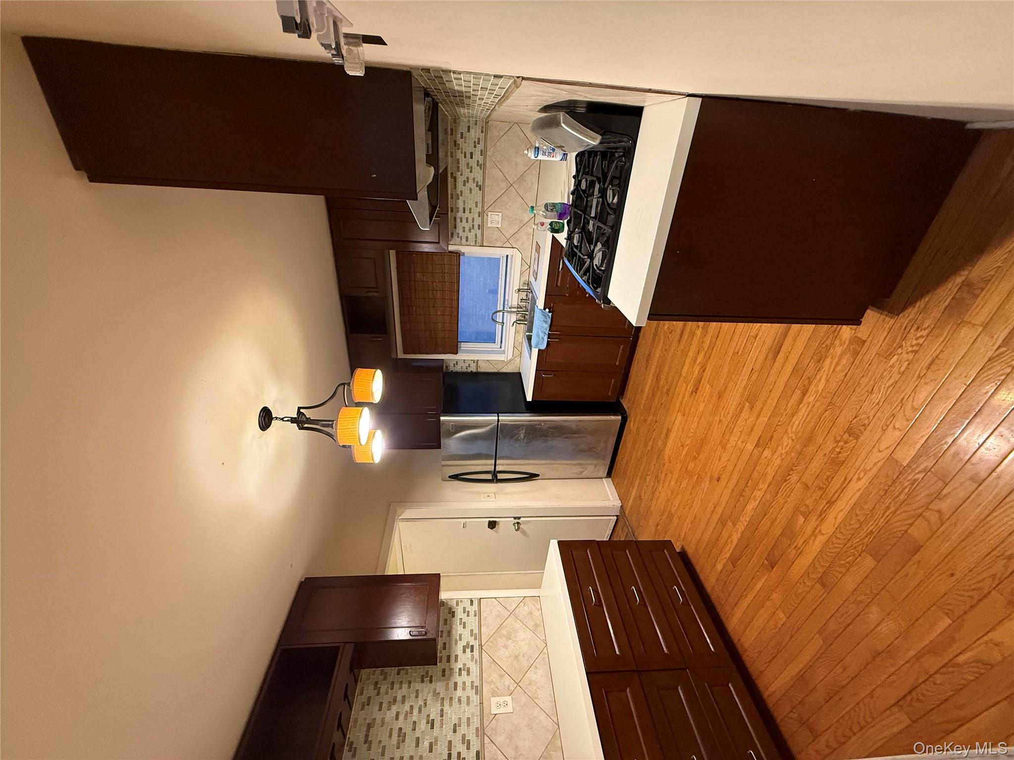 a kitchen with stainless steel appliances granite countertop a sink a stove and a refrigerator