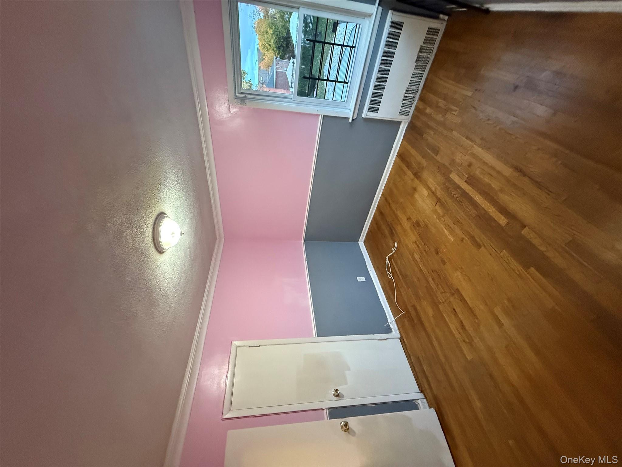 109-11 225th Street, Unit 2 Queens, NY 11429 - Photo 12 of 13 a view of an empty room with window and wooden floor