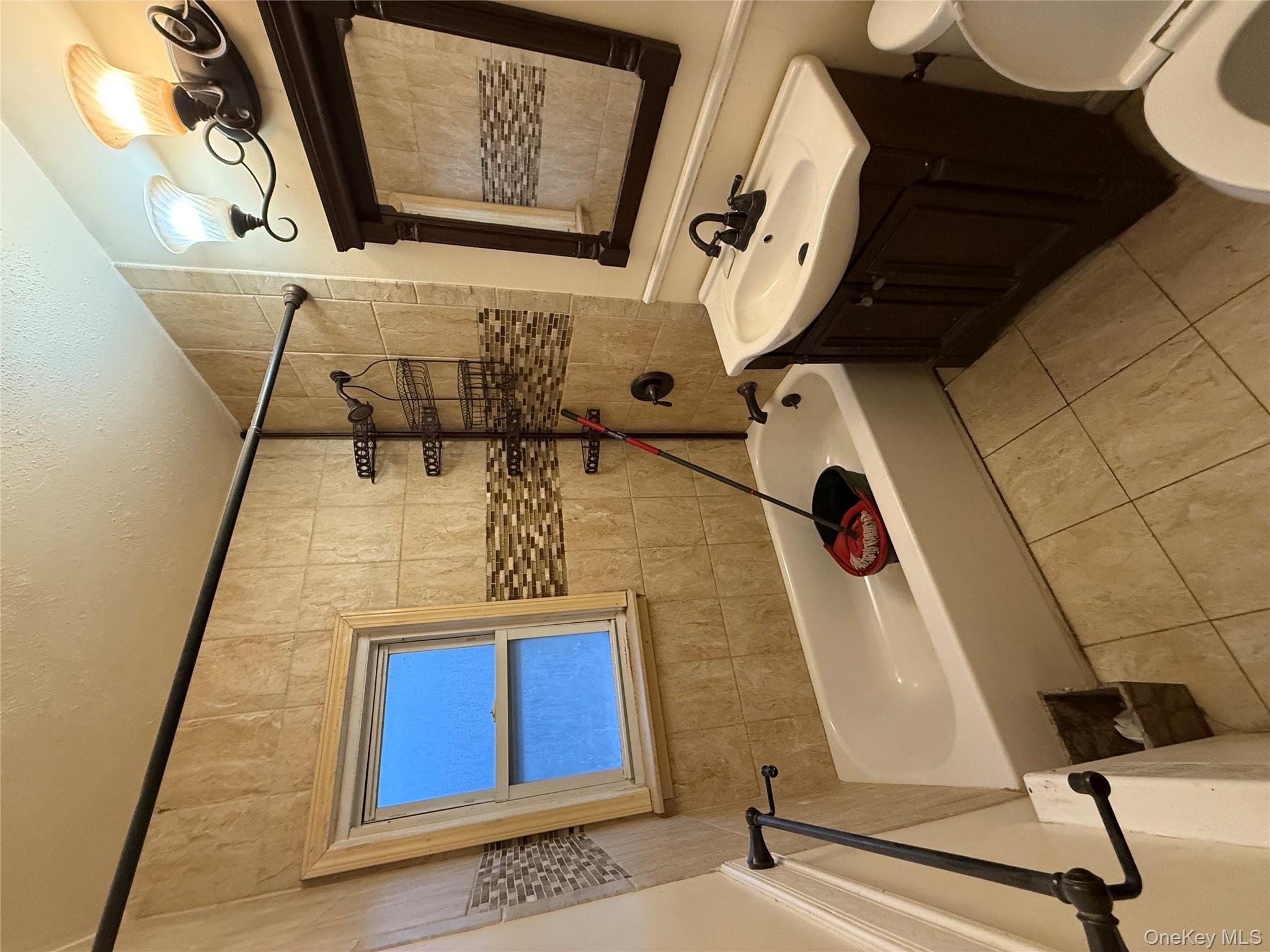 109-11 225th Street, Unit 2 Queens, NY 11429 - Photo 13 of 13 a bathroom with a sink and a mirror