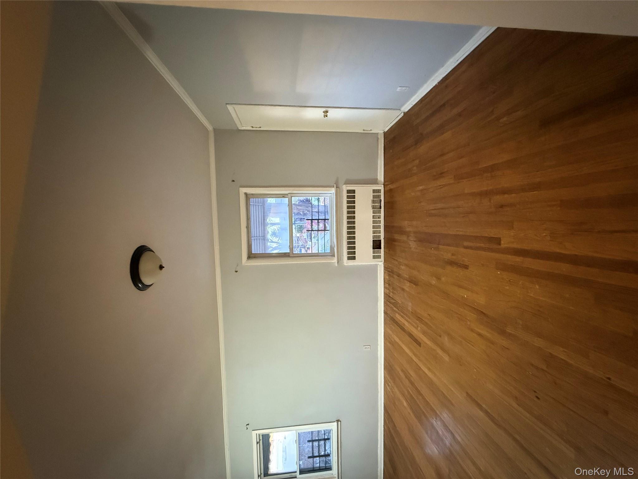 109-11 225th Street, Unit 2 Queens, NY 11429 - Photo 6 of 13 a view of an empty room with a window and wooden floor