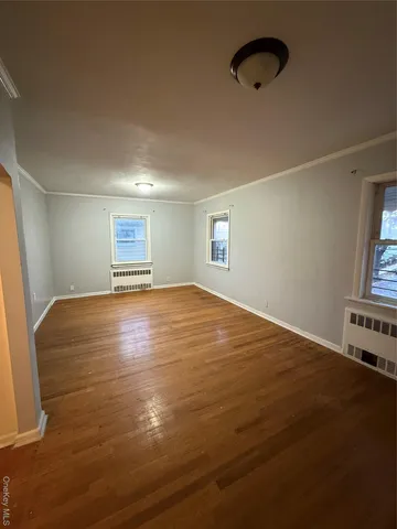 wooden floor in an empty room with a fireplace