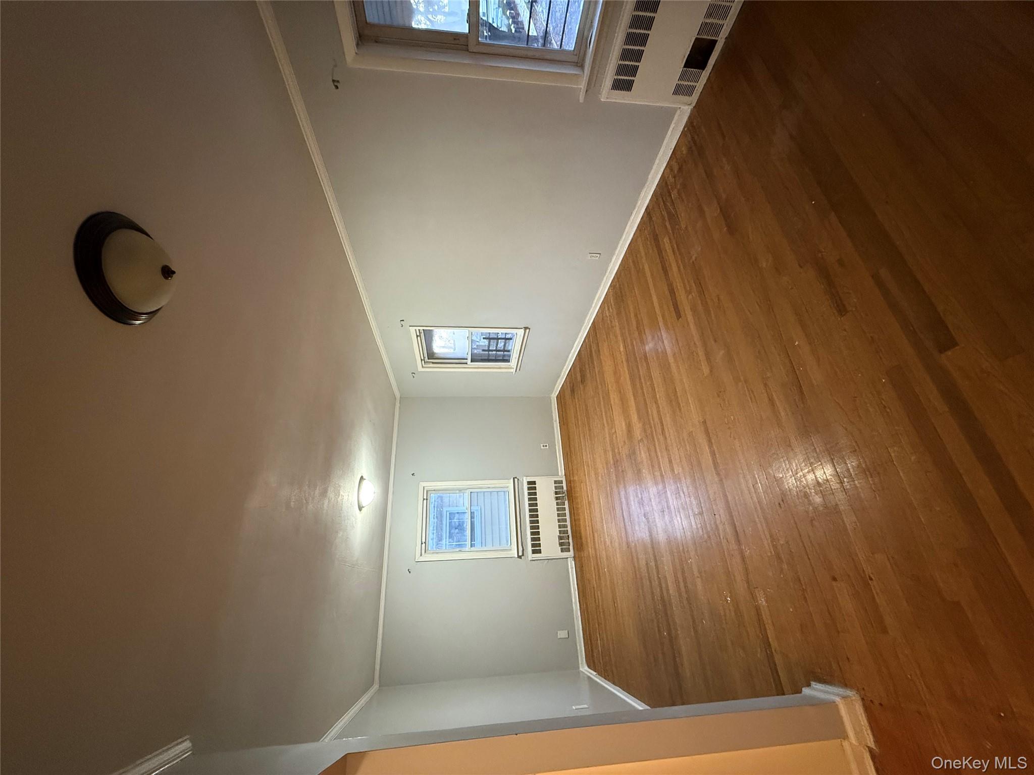 109-11 225th Street, Unit 2 Queens, NY 11429 - Photo 7 of 13 an empty room with windows