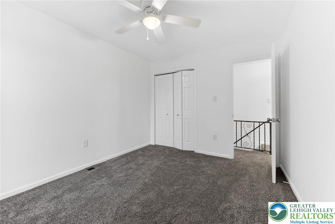 708 Cherokee Street Bethlehem, PA 18015 - Photo 17 of 25 an empty room with a ceiling fan and carpet