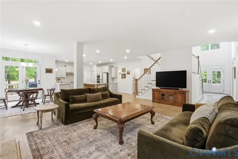 a kitchen with kitchen island a stove a sink a counter space and a refrigerator
