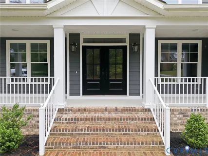 a view of a hallway with windows and stairs