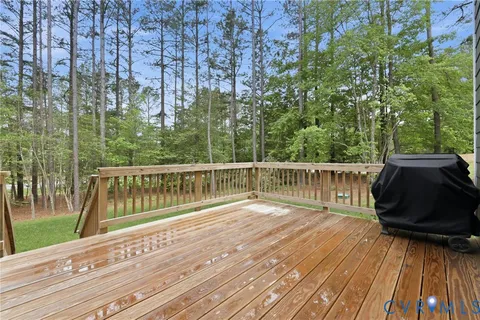 an aerial view of green landscape with trees houses and lake view