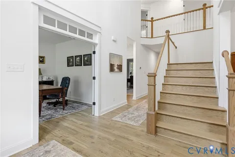 a living room with furniture a rug and a window