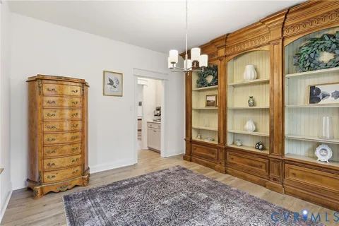 a living room with furniture a fireplace and a table