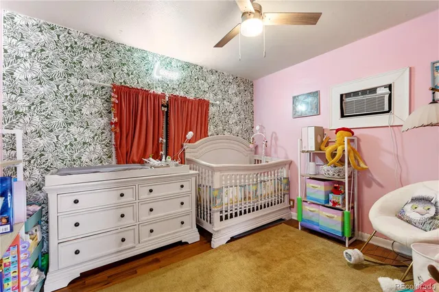 a bedroom with furniture and a baby crib