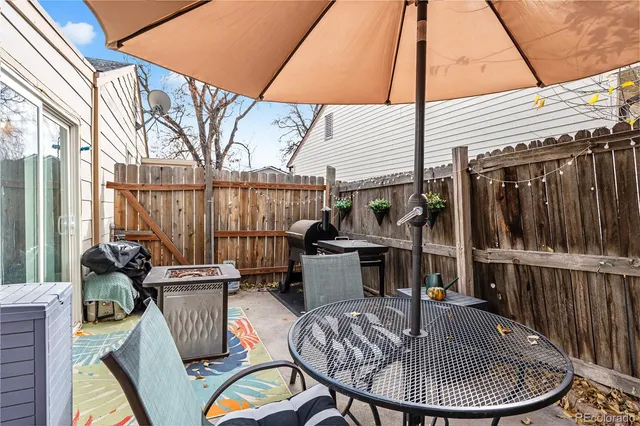 a view of a patio with a dining table and chairs