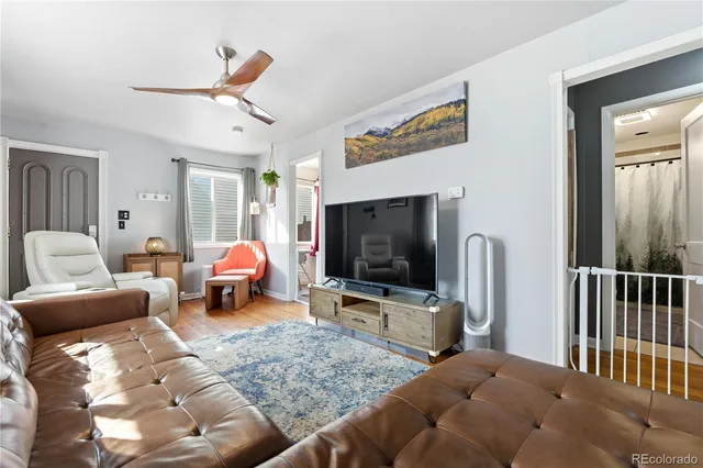 a bedroom with furniture and a flat screen tv