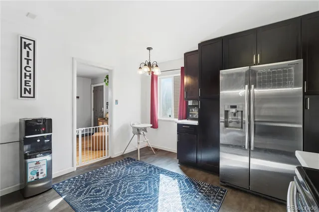 a kitchen with a refrigerator and cabinets