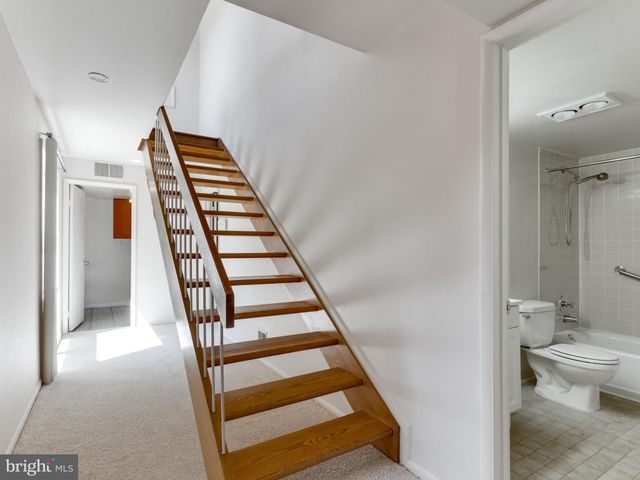 a view of a hallway with wooden floor and entryway