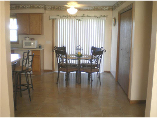 6780 Friday Road Byron, IL 61010 - Photo 4 of 6 a view of a dining room with furniture and window