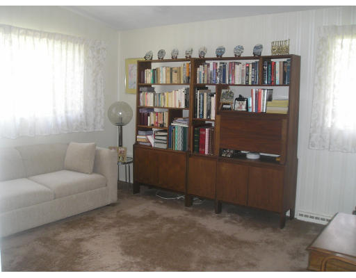 17 Tirrell Crescent Newton, MA 02467 - Photo 6 of 10 a living room with furniture and a bookshelf