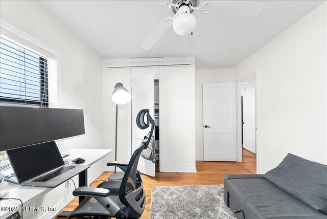a living room with furniture a flat screen tv and a window