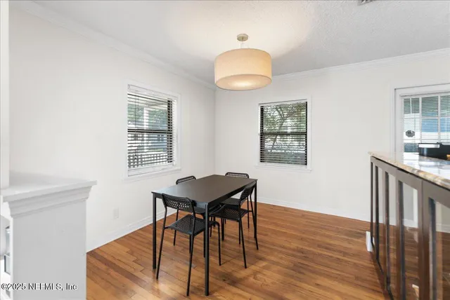 a view of a workspace with furniture and wooden floor