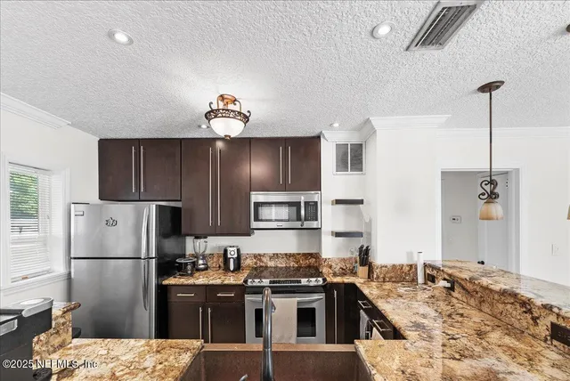 a kitchen with a refrigerator and a sink