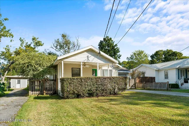 a front view of a house with a garden and yard