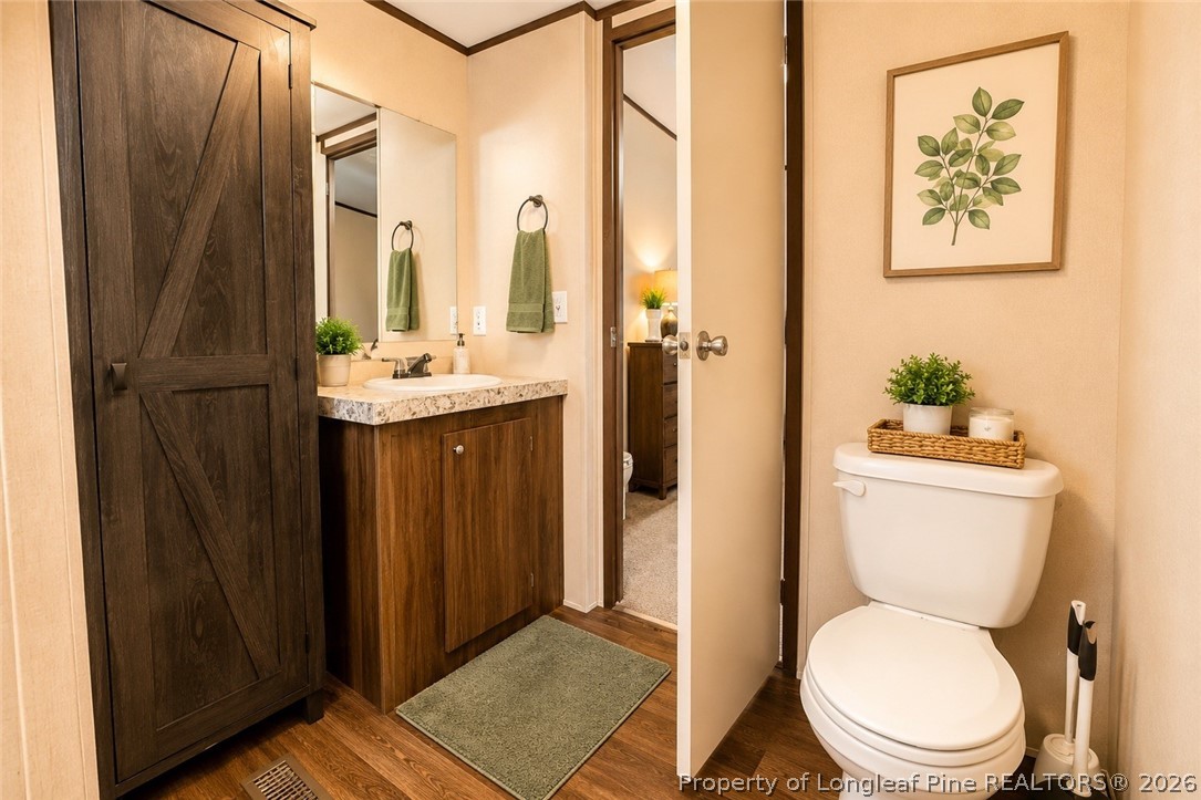 466 Ralph Hunt Boulevard Orrum, NC 28369 - Photo 9 of 17 a bathroom with a toilet a sink and a window
