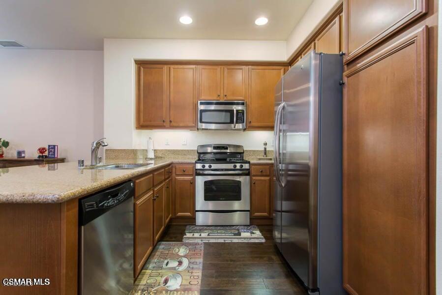 1654 Heywood Street, Unit D Simi Valley, CA 93065 - Photo 5 of 14 a kitchen with stainless steel appliances granite countertop a stove and a refrigerator