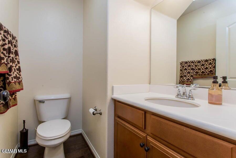 1654 Heywood Street, Unit D Simi Valley, CA 93065 - Photo 7 of 14 a bathroom with a granite countertop toilet sink and mirror