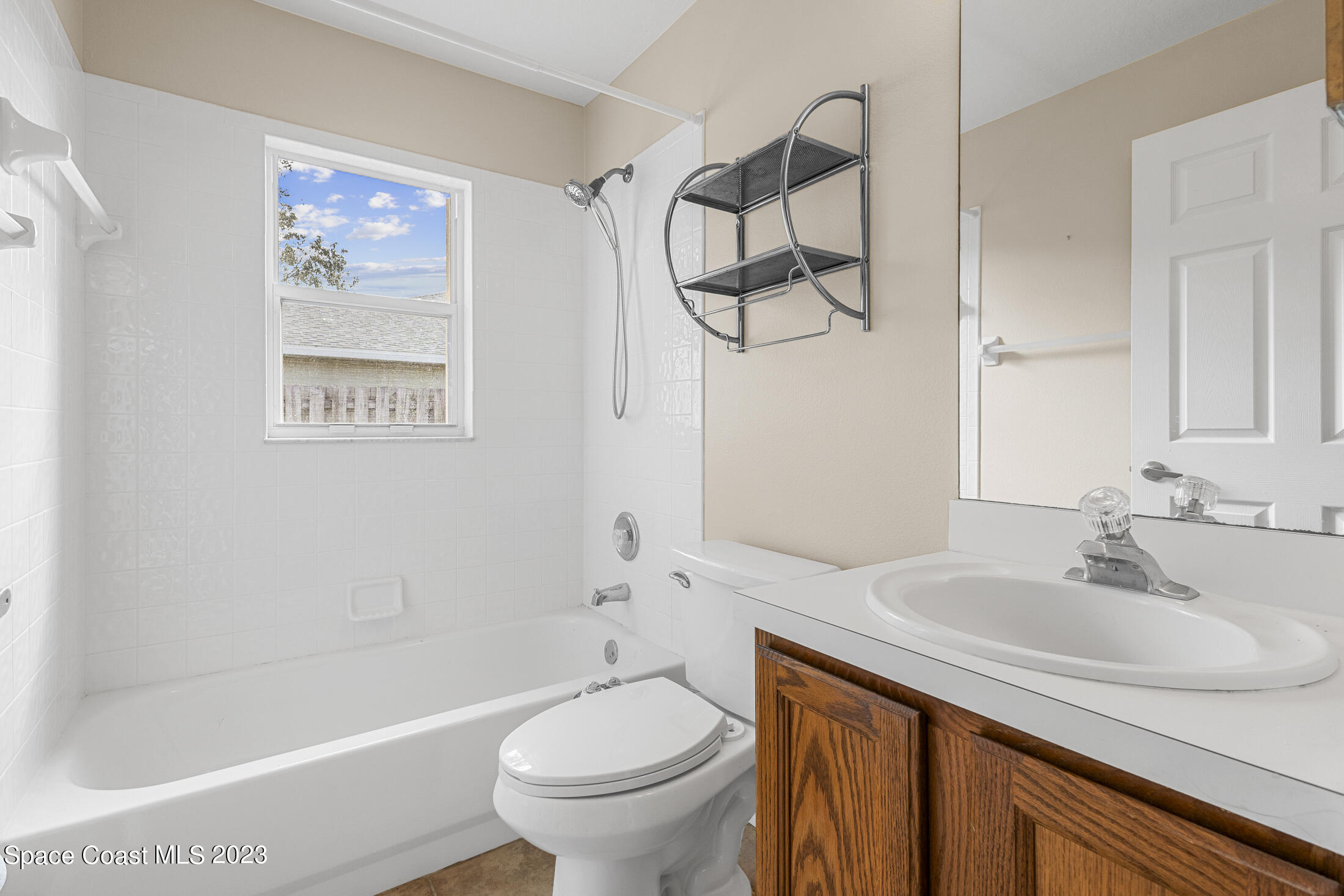 813 Cebu Place Melbourne, FL 32940 - Photo 12 of 25 a bathroom with a sink a toilet and shower