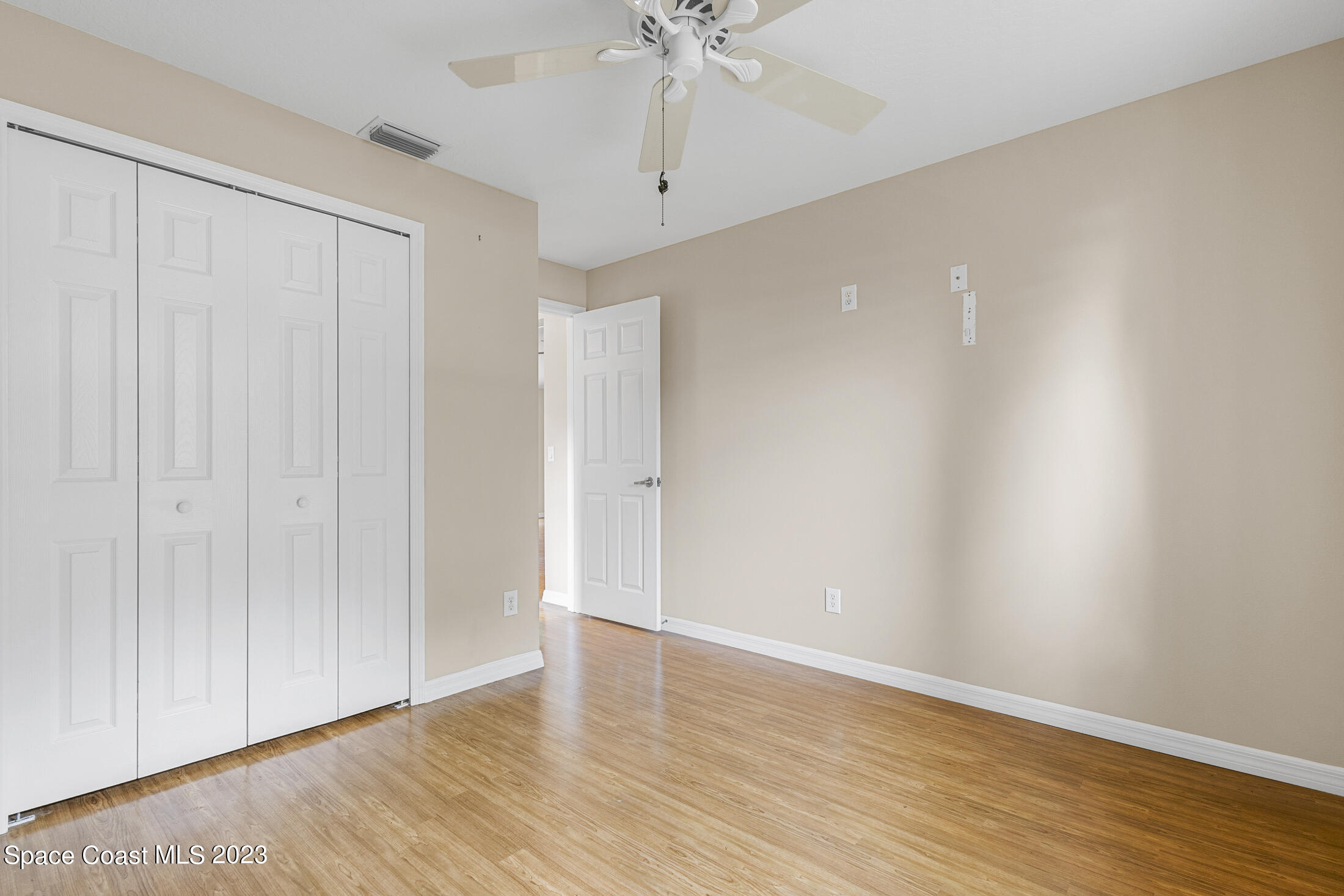 813 Cebu Place Melbourne, FL 32940 - Photo 13 of 25 a view of an empty room with wooden floor