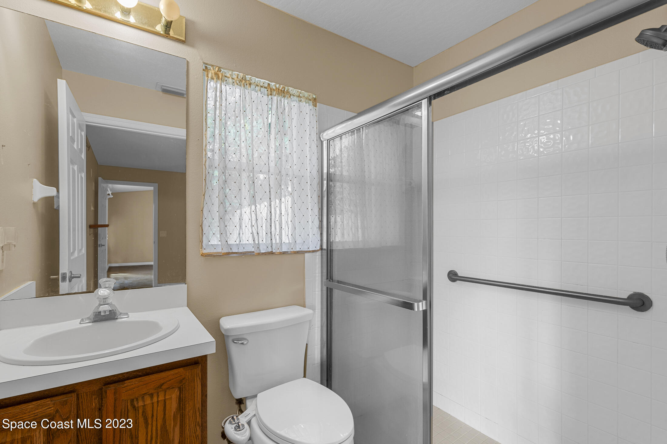 813 Cebu Place Melbourne, FL 32940 - Photo 17 of 25 a bathroom with a sink toilet and shower
