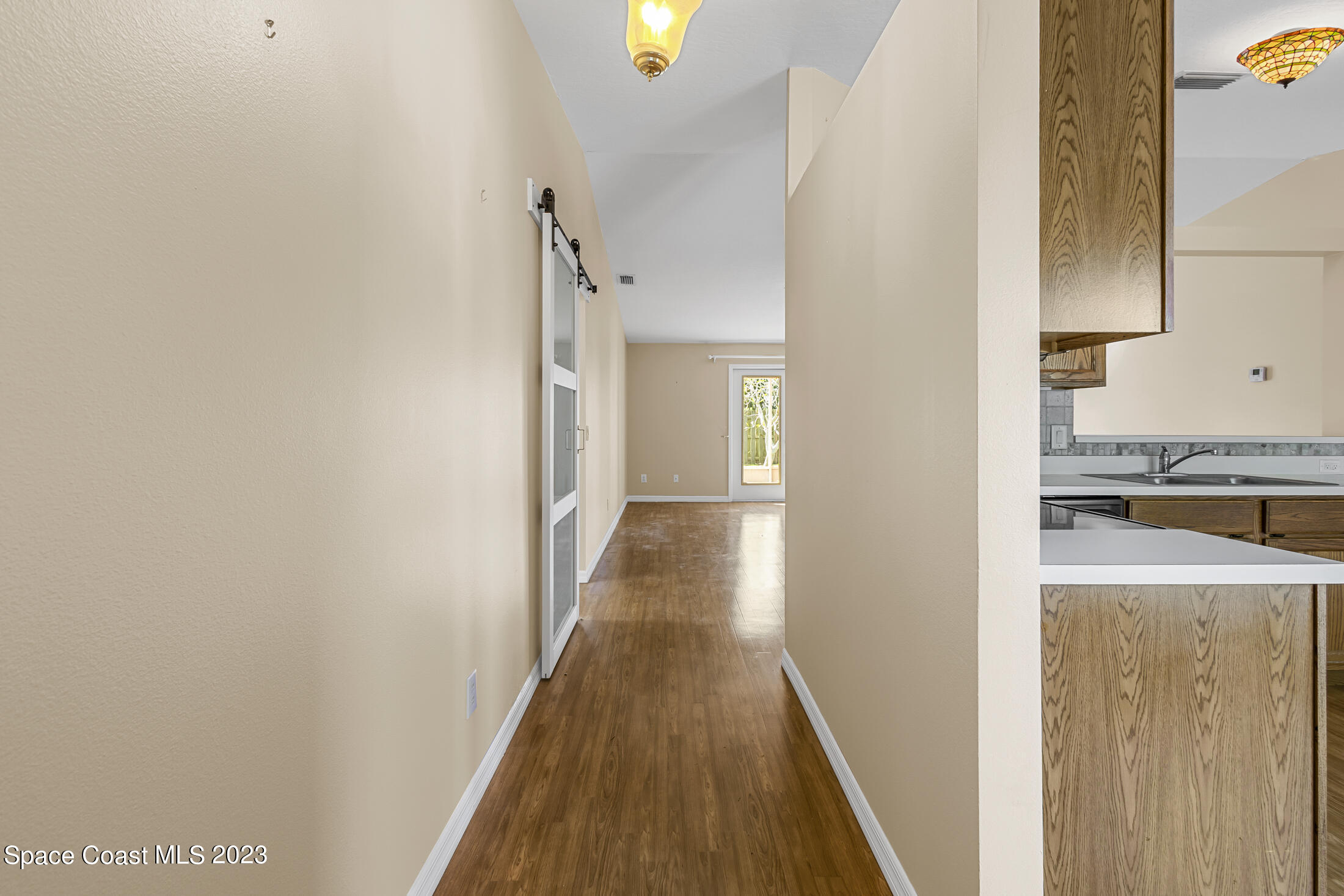 813 Cebu Place Melbourne, FL 32940 - Photo 18 of 25 a view of a kitchen from the hallway