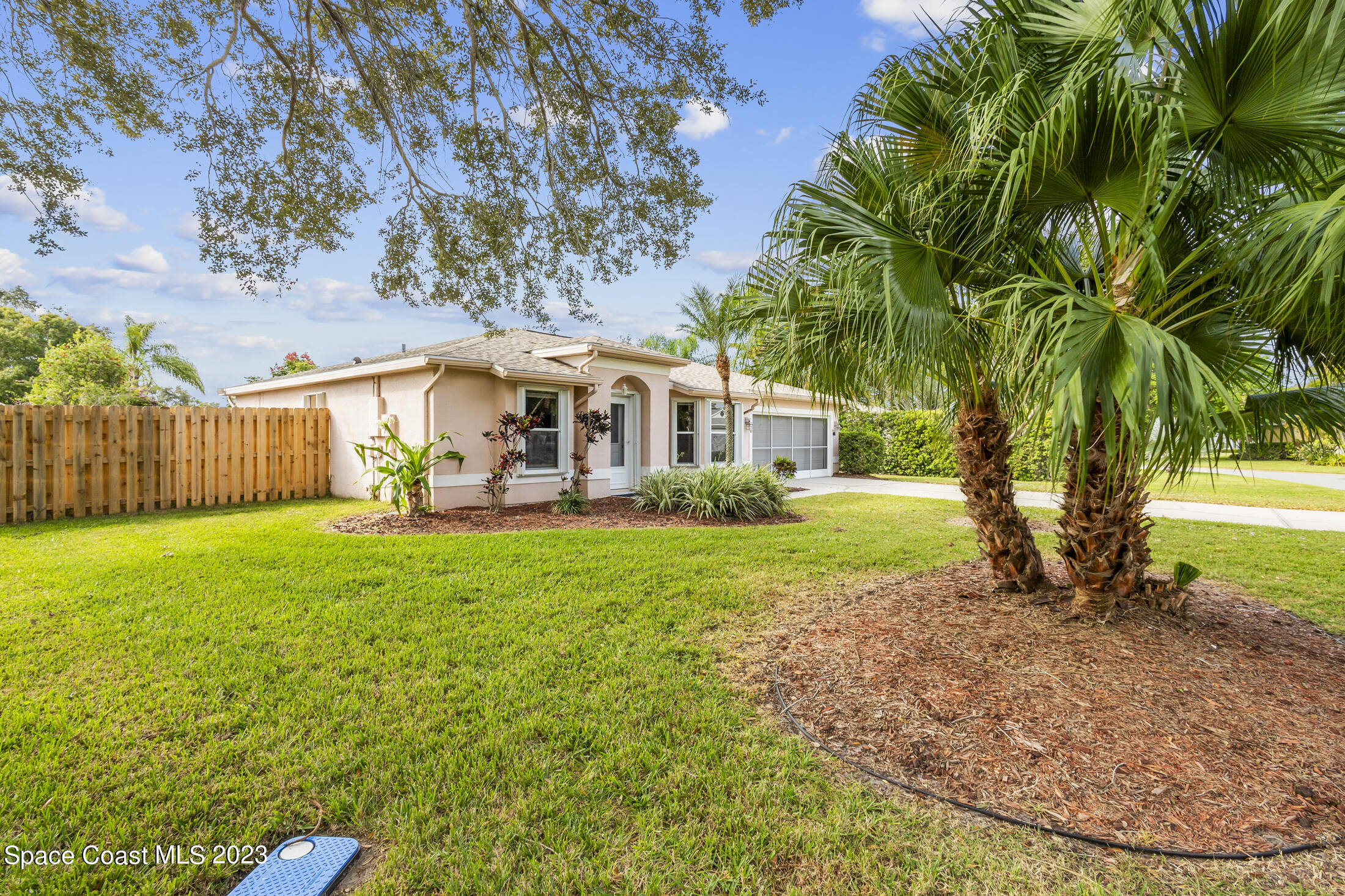 813 Cebu Place Melbourne, FL 32940 - Photo 2 of 25 a view of a house with backyard and sitting area