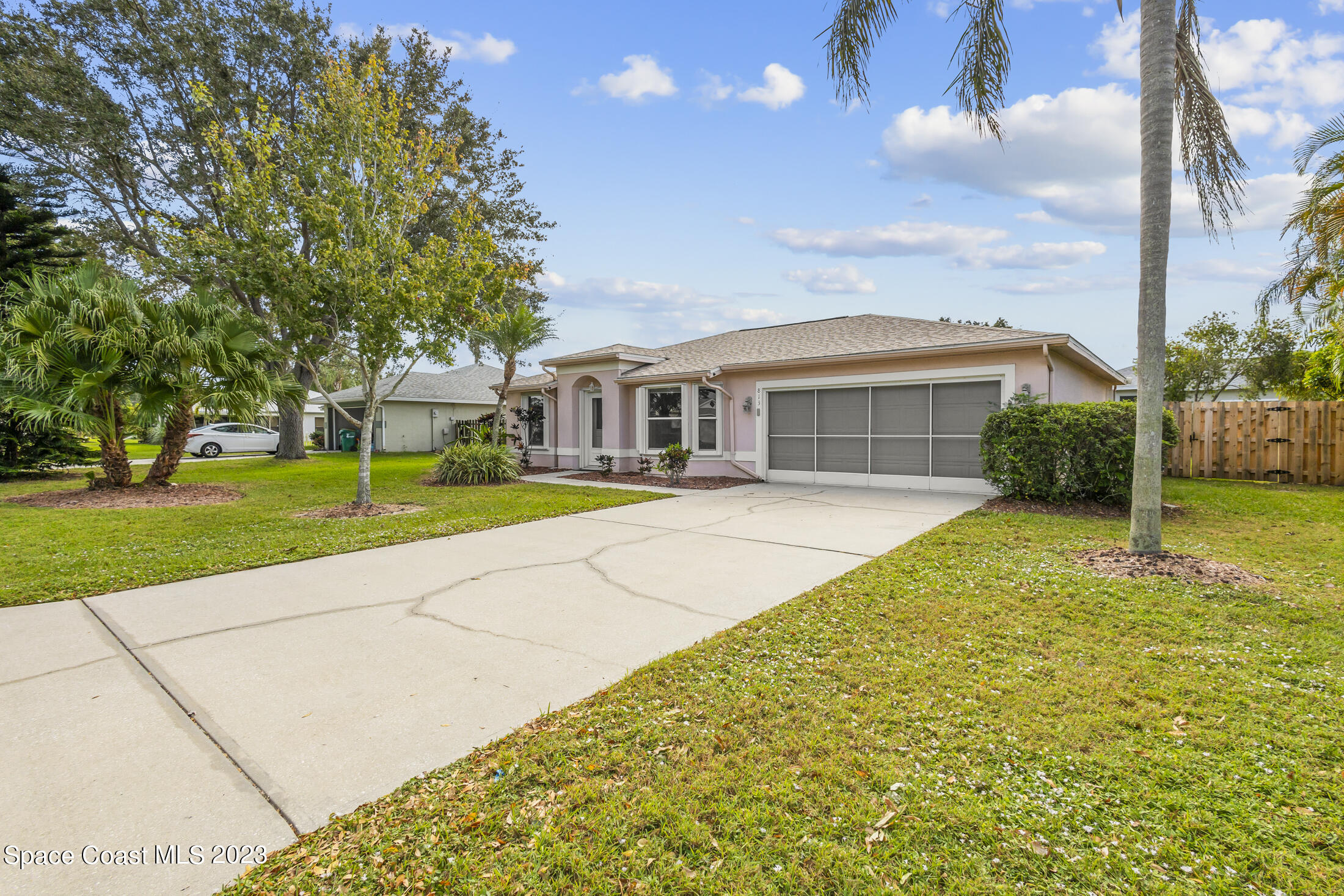 813 Cebu Place Melbourne, FL 32940 - Photo 3 of 25 a view of house with yard outdoor seating and barbeque oven