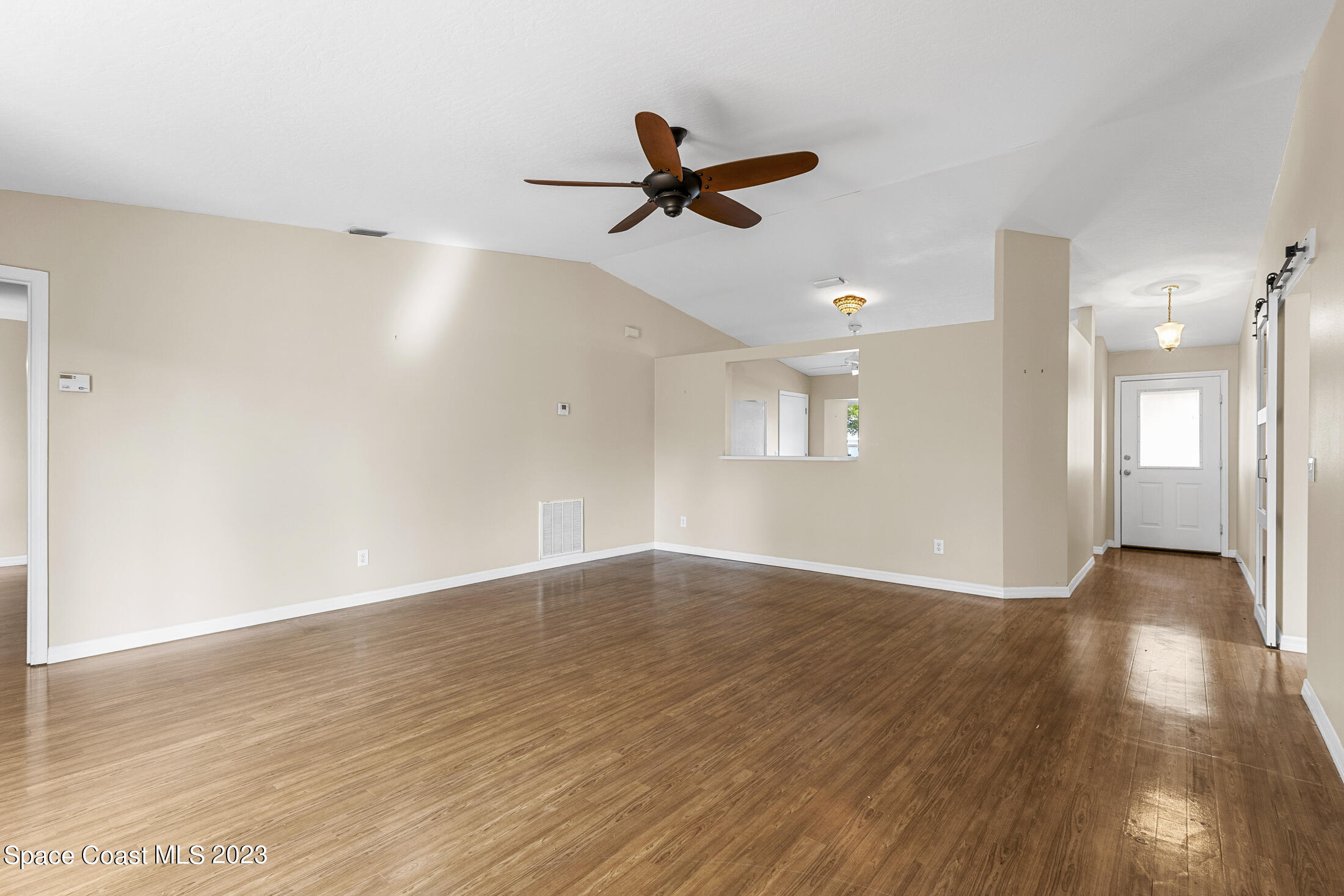 813 Cebu Place Melbourne, FL 32940 - Photo 8 of 25 a view of empty room with wooden floor and fan
