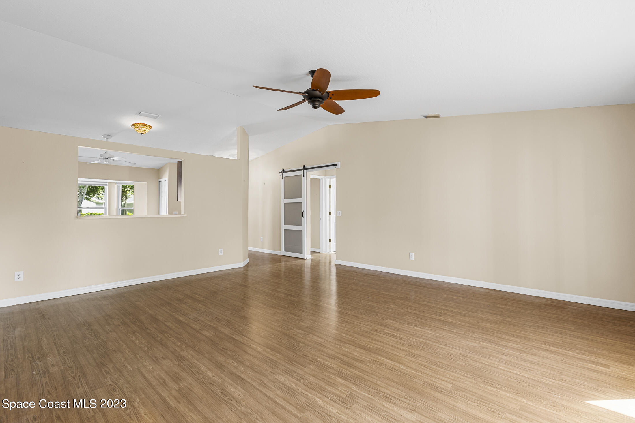 813 Cebu Place Melbourne, FL 32940 - Photo 9 of 25 wooden floor in an empty room with a window