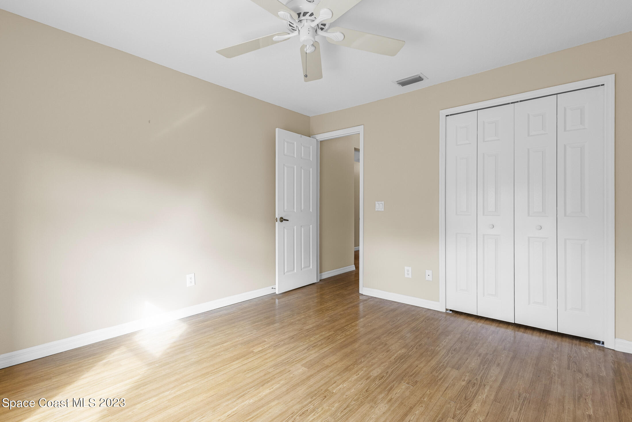 813 Cebu Place Melbourne, FL 32940 - Photo 10 of 25 a view of an empty room with wooden floor