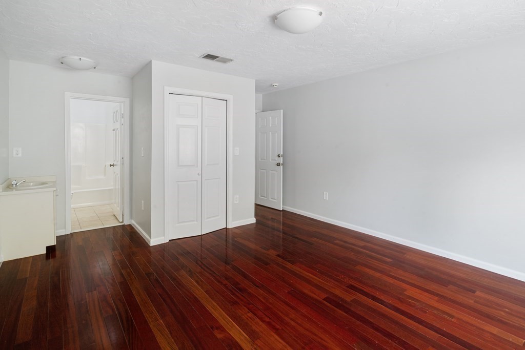 68 Regent Circle, Unit 68 Brookline, MA 02445 - Photo 15 of 21 a view of empty room with wooden floor