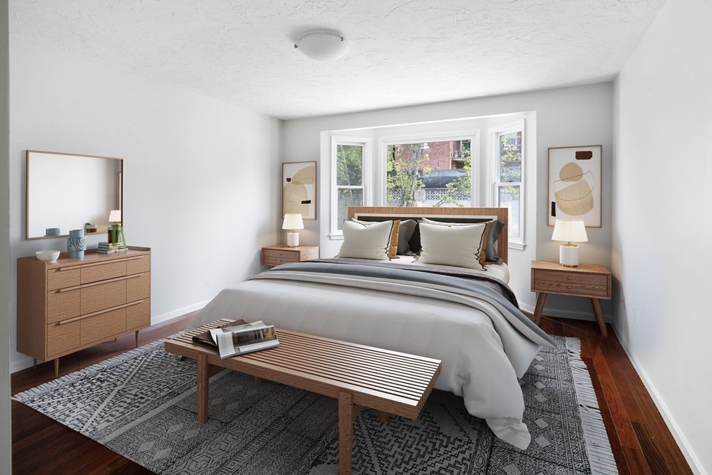 68 Regent Circle, Unit 68 Brookline, MA 02445 - Photo 17 of 21 a bedroom with a bed and wooden floor