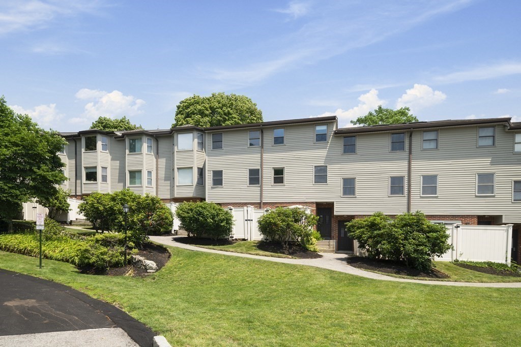 68 Regent Circle, Unit 68 Brookline, MA 02445 - Photo 21 of 21 a front view of a house with a yard