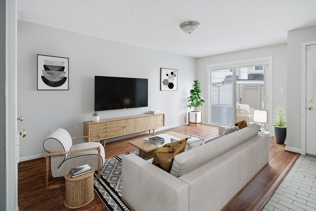 68 Regent Circle, Unit 68 Brookline, MA 02445 - Photo 7 of 21 a living room with furniture and a flat screen tv