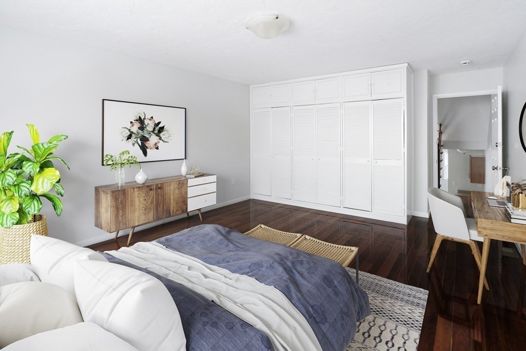 68 Regent Circle, Unit 68 Brookline, MA 02445 - Photo 10 of 21 a bedroom with a large bed and a couch