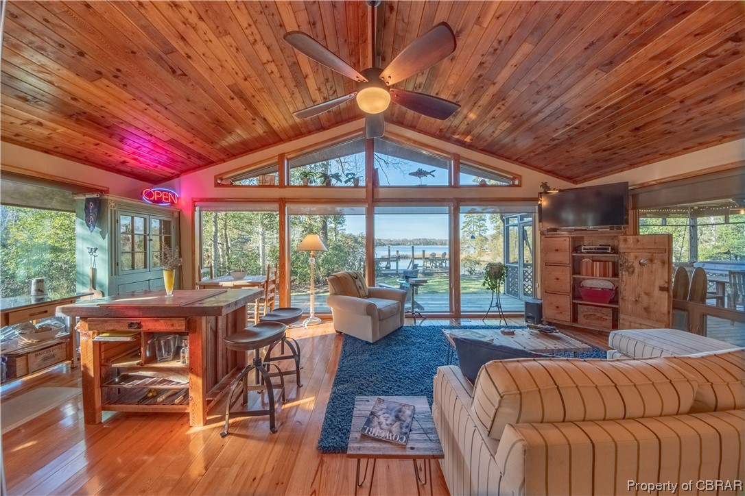 1239 Kelley Neck Road Lancaster, VA 22503 - Photo 23 of 48 Living room with wooden ceiling, vaulted ceiling, light wood-type flooring, and ceiling fan