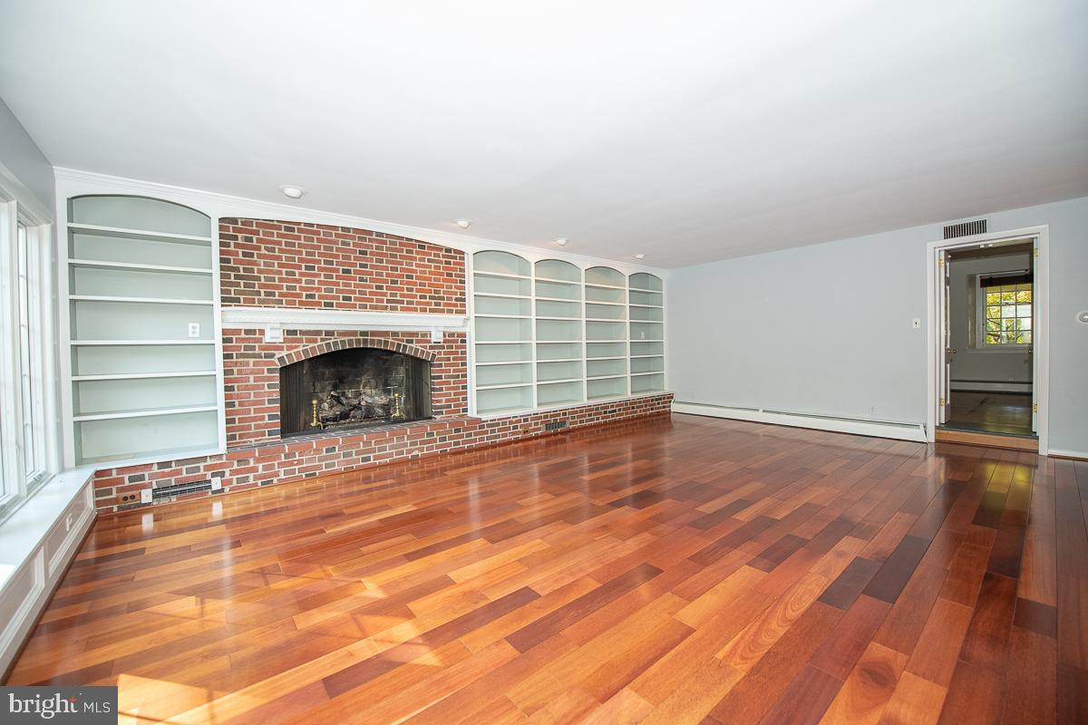 933 Merion Square Road Gladwyne, PA 19035 - Photo 13 of 38 Many shelves flank the floor to ceiling fireplace!