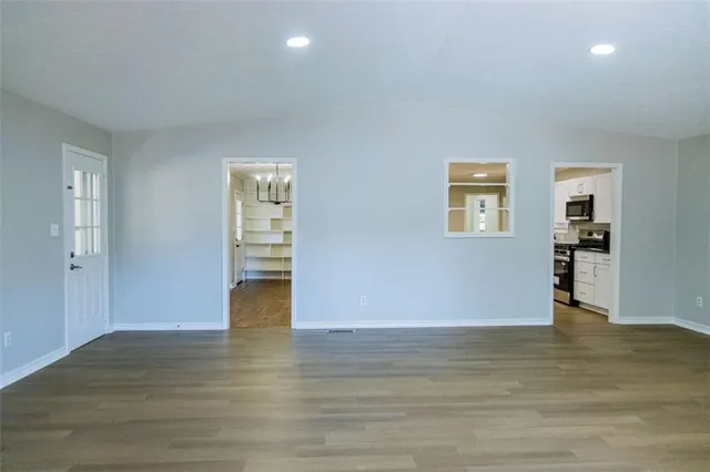 a view of empty room with wooden floor