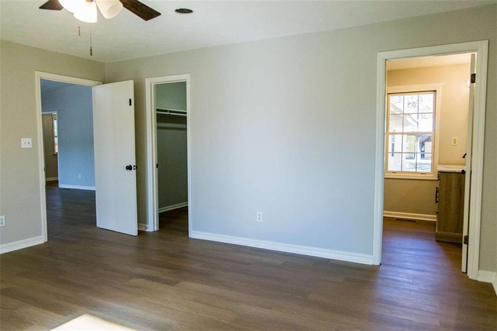 83 Manning Lake Road Rome, GA 30165 - Photo 18 of 26 an empty room with wooden floor and a ceiling fan