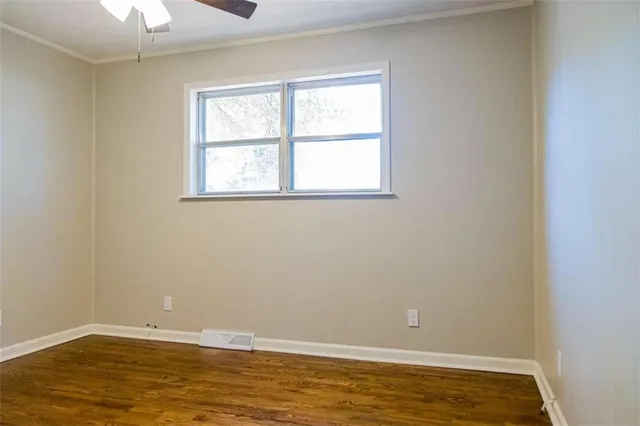 a view of room with window and ceiling fan