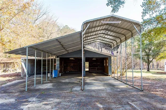 a view of a chair and table in the back yard of the house