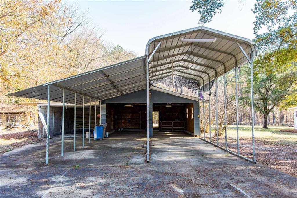 83 Manning Lake Road Rome, GA 30165 - Photo 7 of 26 a view of a chair and table in the back yard of the house