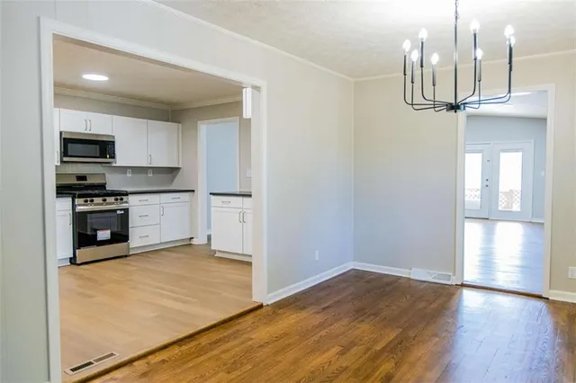 a kitchen with stainless steel appliances granite countertop a refrigerator and a stove top oven