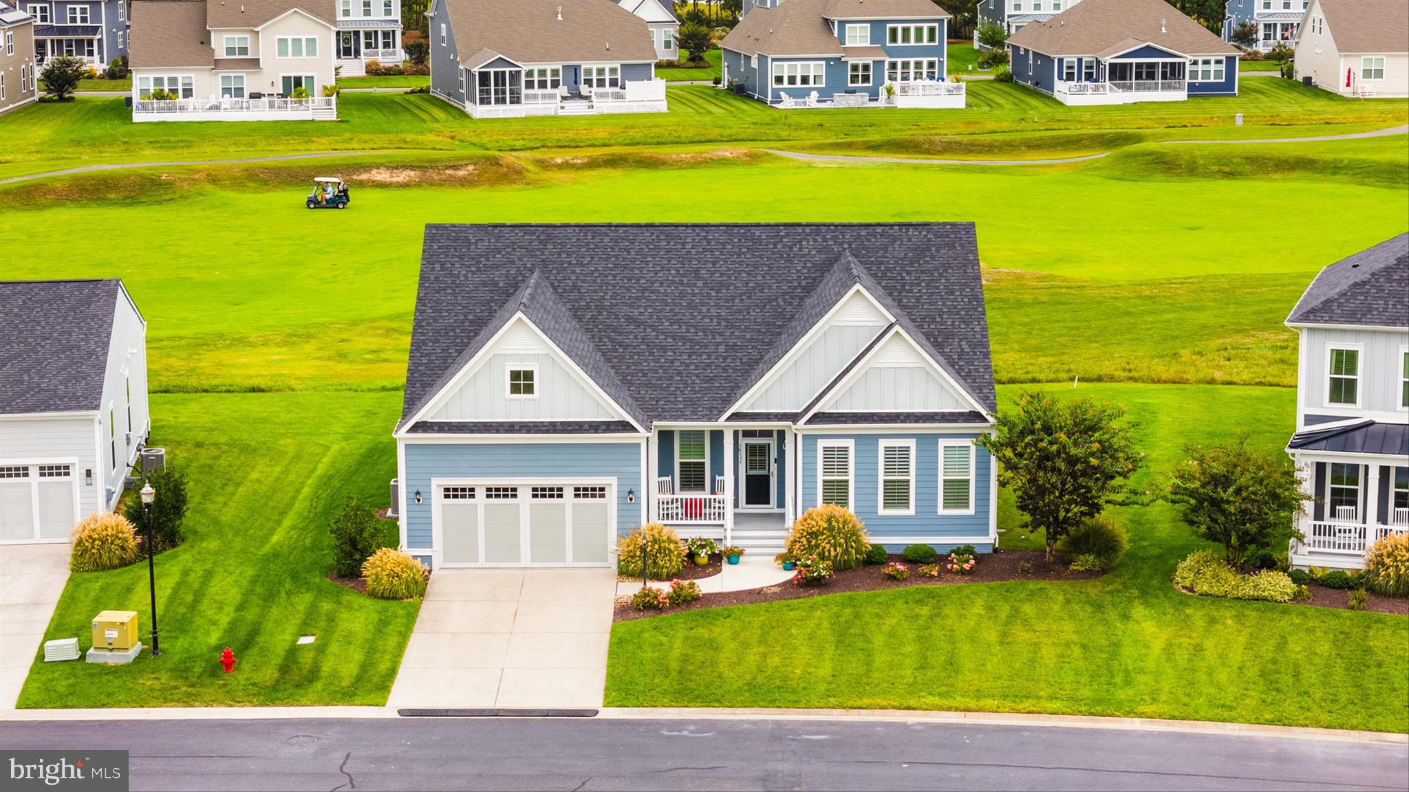 an aerial view of a house with a swimming pool garden and patio