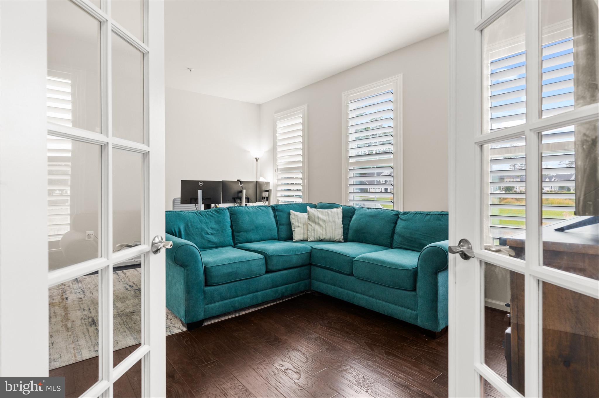 10135 Fast Colors Lane Berlin, MD 21811 - Photo 18 of 63 a living room with furniture and a large window